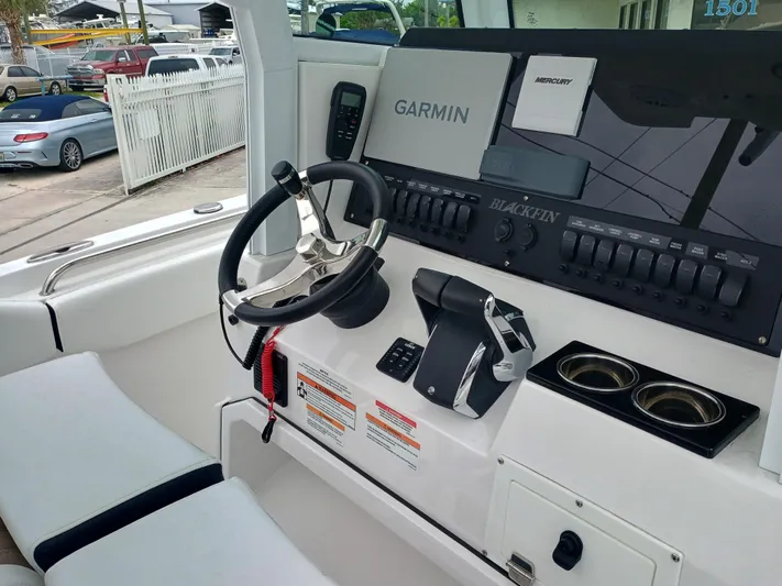 252-449 Yacht Photos Pics 2025 Blackfin 252 CC boat dashboard with Garmin navigation and Mercury controls.