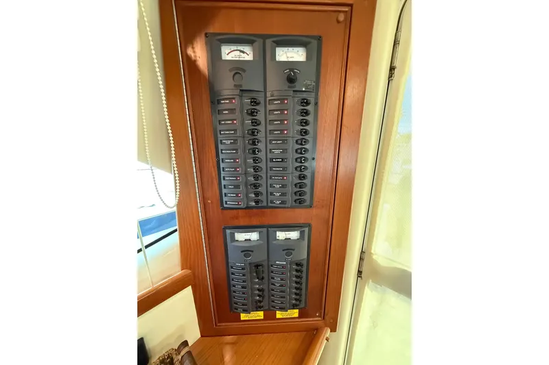  Yacht Photos Pics Electrical panel on 2005 Riviera 40 Flybridge yacht, featuring multiple switches and meters.