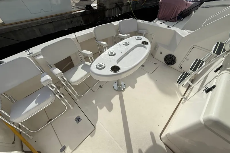  Yacht Photos Pics 2005 Riviera 40 Flybridge yacht deck with seating and table setup.