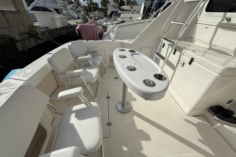  Yacht Photos Pics 2005 Riviera 40 Flybridge yacht deck with seating and table setup.