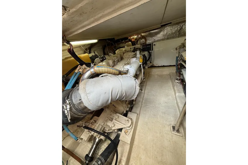  Yacht Photos Pics Engine room of a 2005 Riviera 40 Flybridge yacht, showcasing mechanical components.