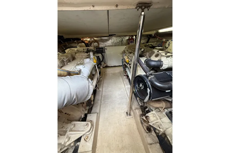  Yacht Photos Pics Engine room of 2005 Riviera 40 Flybridge yacht, showcasing dual engines and mechanical components.