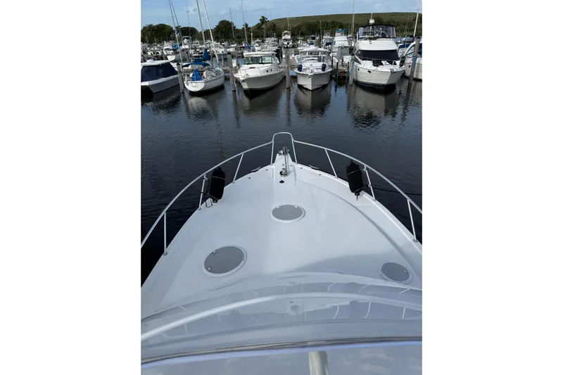  Yacht Photos Pics Bow view of 2005 Riviera 40 Flybridge yacht docked in a marina.