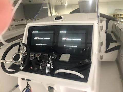  Yacht Photos Pics 2019 Midnight Express 39 Cuddy boat dashboard with dual screens and steering wheel.