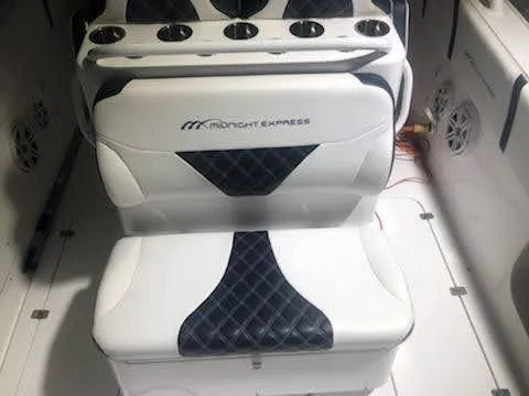  Yacht Photos Pics 2019 Midnight Express 39 Cuddy boat interior with cushioned seating and cup holders.