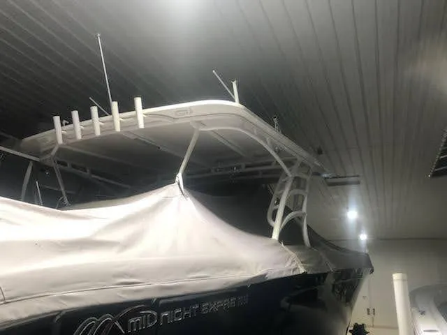  Yacht Photos Pics 2019 Midnight Express 39 Cuddy boat in storage, partially covered, with visible T-top and antennas.