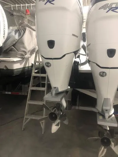  Yacht Photos Pics 2019 Midnight Express 39 Cuddy boat engines in storage, featuring dual outboard motors.