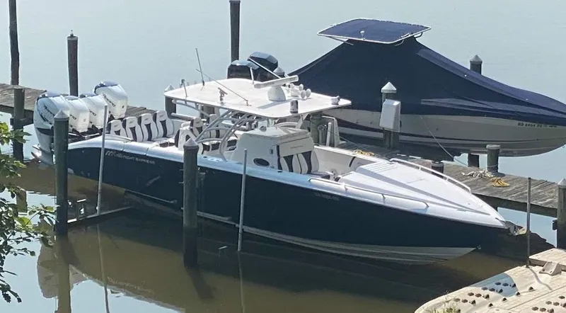  Yacht Photos Pics 2019 Midnight Express 39 Cuddy boat docked, featuring sleek design and powerful engines.
