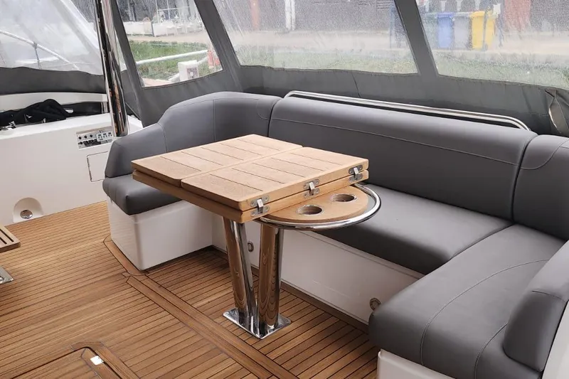 Alexstar Yacht Photos Pics Luxurious Sunseeker Manhattan 68 yacht interior with elegant seating and wooden table, 2021 model.