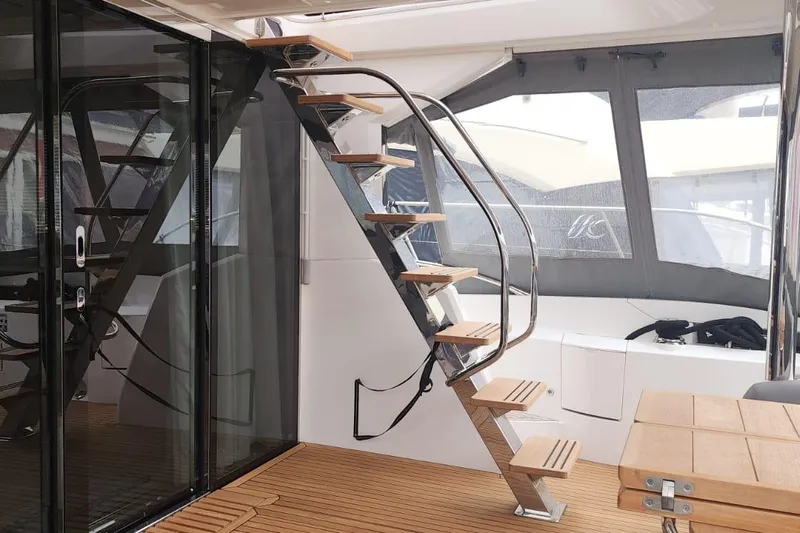 Alexstar Yacht Photos Pics Interior of 2021 Sunseeker Manhattan 68 yacht with modern staircase and wooden flooring.