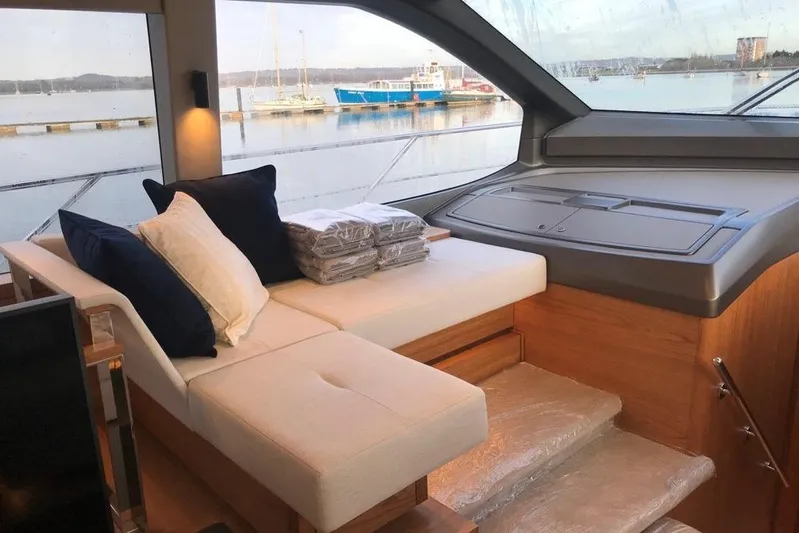 Alexstar Yacht Photos Pics Interior of 2021 Sunseeker Manhattan 68 yacht with elegant seating and scenic view.