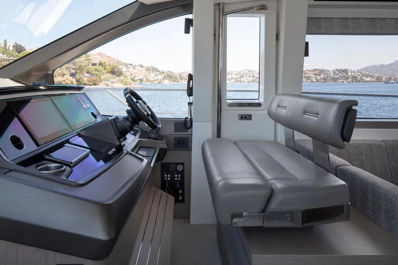 Alexstar Yacht Photos Pics Luxurious 2021 Sunseeker Manhattan 68 yacht interior with modern helm and seating.