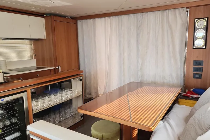 Alexstar Yacht Photos Pics Interior of 2021 Sunseeker Manhattan 68 yacht with dining area and kitchenette.