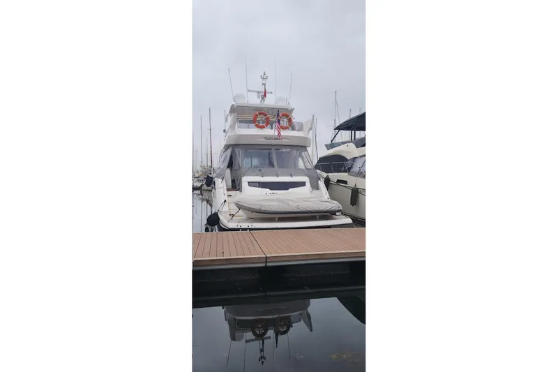 Alexstar Yacht Photos Pics 2021 Sunseeker Manhattan 68 yacht docked at marina, front view.