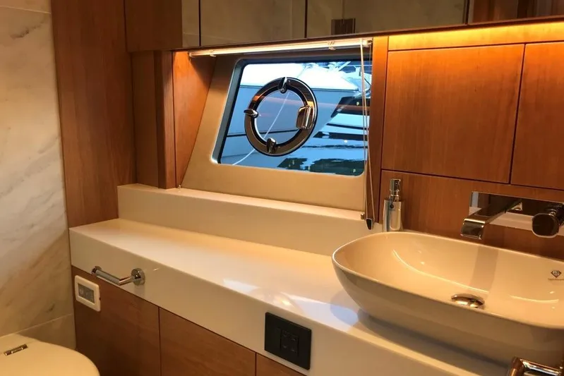 Alexstar Yacht Photos Pics Luxurious bathroom interior of 2021 Sunseeker Manhattan 68 yacht with modern fixtures.