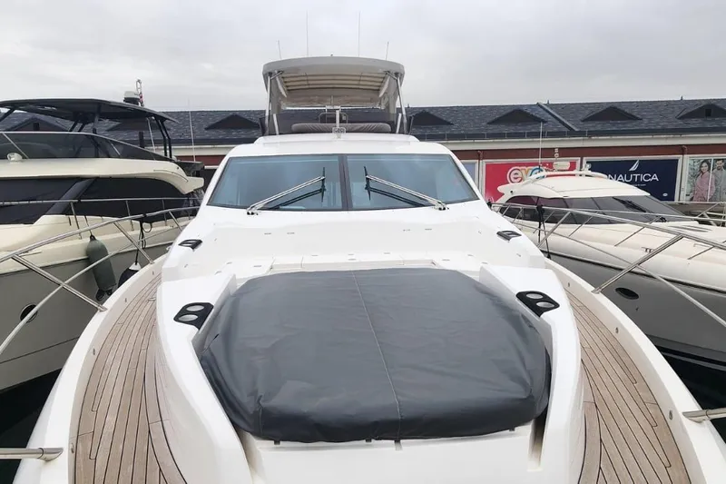 Alexstar Yacht Photos Pics 2021 Sunseeker Manhattan 68 yacht docked, showcasing sleek design and spacious deck.