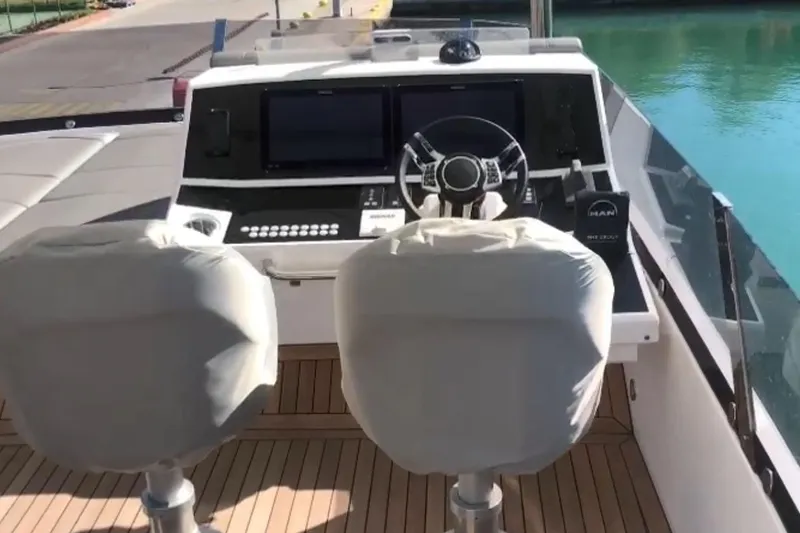 Alexstar Yacht Photos Pics Helm of 2021 Sunseeker Manhattan 68 yacht with dual seats and modern controls.
