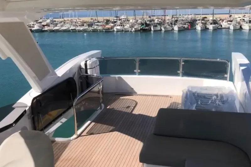 Alexstar Yacht Photos Pics Sunseeker Manhattan 68 yacht deck, 2021 model, overlooking marina with moored boats.