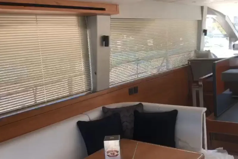 Alexstar Yacht Photos Pics Interior of 2021 Sunseeker Manhattan 68 yacht with modern seating and blinds.