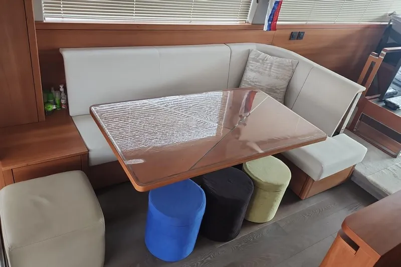 Alexstar Yacht Photos Pics Interior of 2021 Sunseeker Manhattan 68 yacht with modern seating and table arrangement.