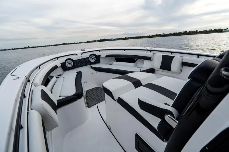 Tidewater 320 Cc Yacht Photos Pics 2020 Tidewater 32 boat interior with black and white seating on calm water.