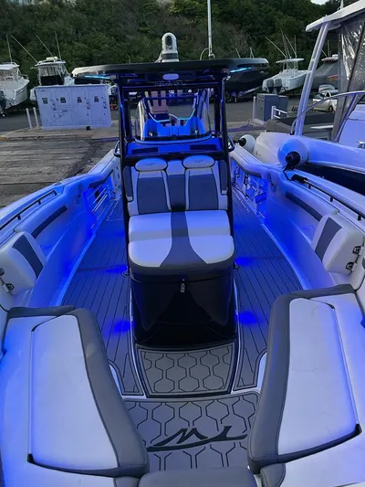 Tidewater 320 Cc Yacht Photos Pics 2020 Tidewater 32 boat with blue LED interior lighting at a marina.