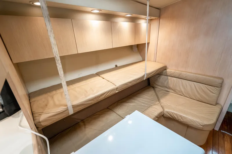Amadeus Yacht Photos Pics 1995 Tiara Yachts 4300 Open interior with beige seating and overhead storage.