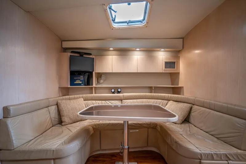 Amadeus Yacht Photos Pics 1995 Tiara Yachts 4300 Open interior with beige leather seating and a skylight.