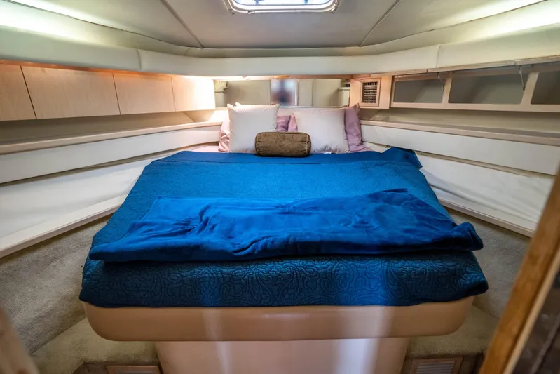 Amadeus Yacht Photos Pics Cozy cabin interior of 1995 Tiara Yachts 4300 Open with blue bedding.