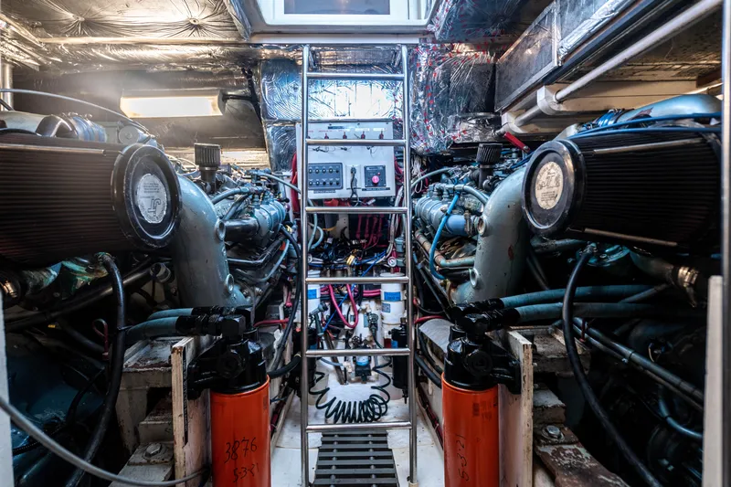 Amadeus Yacht Photos Pics Engine room of a 1995 Tiara Yachts 4300 Open, showcasing dual engines and control panel.