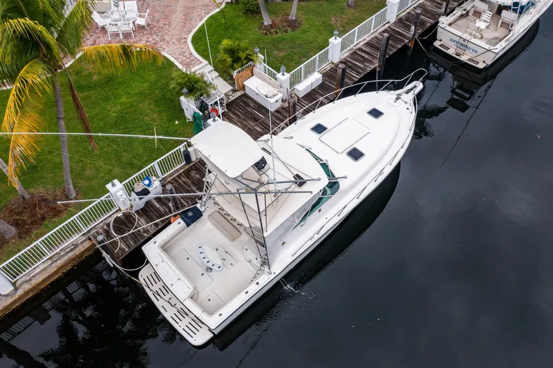 Amadeus Yacht Photos Pics Aerial view of 1995 Tiara Yachts 4300 Open docked by a waterfront.