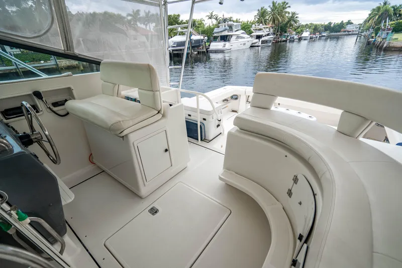 Amadeus Yacht Photos Pics 1995 Tiara Yachts 4300 Open interior with seating, docked by a serene waterfront.