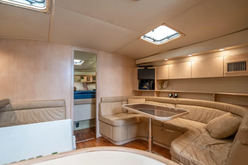 Amadeus Yacht Photos Pics 1995 Tiara Yachts 4300 Open interior with beige seating and wooden accents.