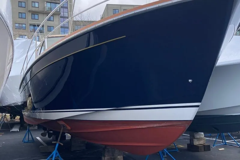 Off-line Yacht Photos Pics 2002 Sabre 36 boat with blue hull on stands, urban background.