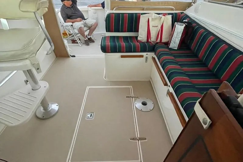 Off-line Yacht Photos Pics Interior of 2002 Sabre 36 boat with striped seating and spacious layout.