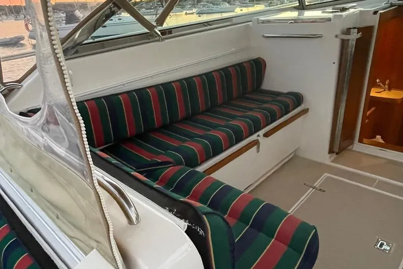 Off-line Yacht Photos Pics Interior of 2002 Sabre 36 boat with striped seating and open cabin door.