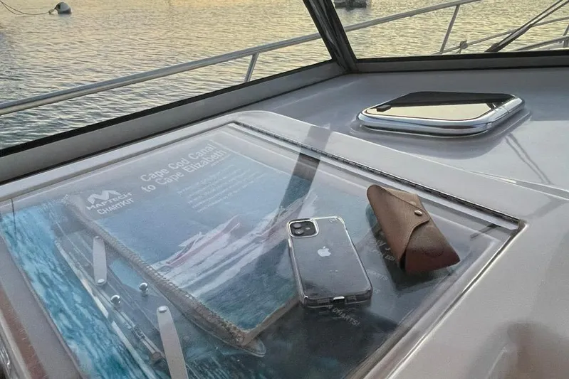 Off-line Yacht Photos Pics Sabre 36 yacht dashboard with phone, sunglasses, and nautical chart, 2002 model.