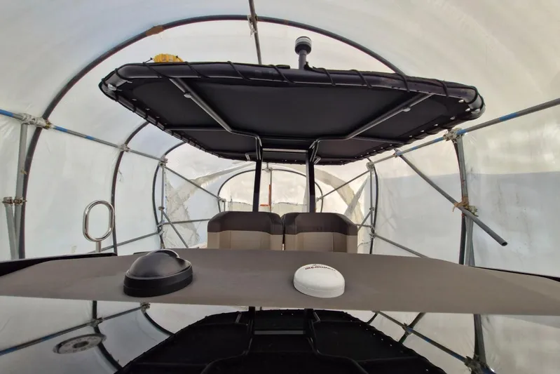 T/t Abie Yacht Photos Pics 2025 Rio Yachts Inagua 36 interior with canopy and seating under protective cover.