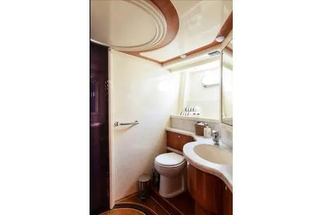 Ventus 21 Yacht Photos Pics Luxurious bathroom in 2003 Ferretti Yachts 760, featuring elegant wood accents and modern fixtures.