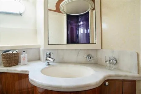 Ventus 21 Yacht Photos Pics Luxurious bathroom in 2003 Ferretti Yachts 760, featuring elegant marble sink and mirror.