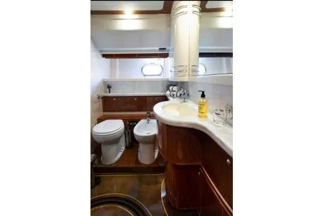Ventus 21 Yacht Photos Pics Luxurious bathroom in 2003 Ferretti Yachts 760, featuring elegant wood finishes and modern fixtures.