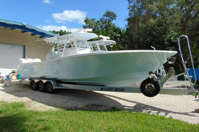 Incognito Yacht Photos Pics 2020 Invincible 36 Open boat on trailer, parked outdoors near a building.