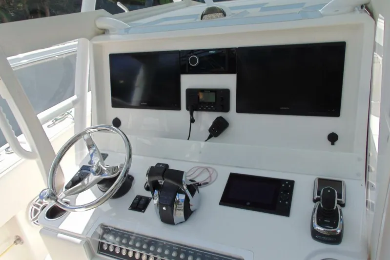 Incognito Yacht Photos Pics Control panel of 2020 Invincible 36 Open boat with steering wheel and electronic displays.