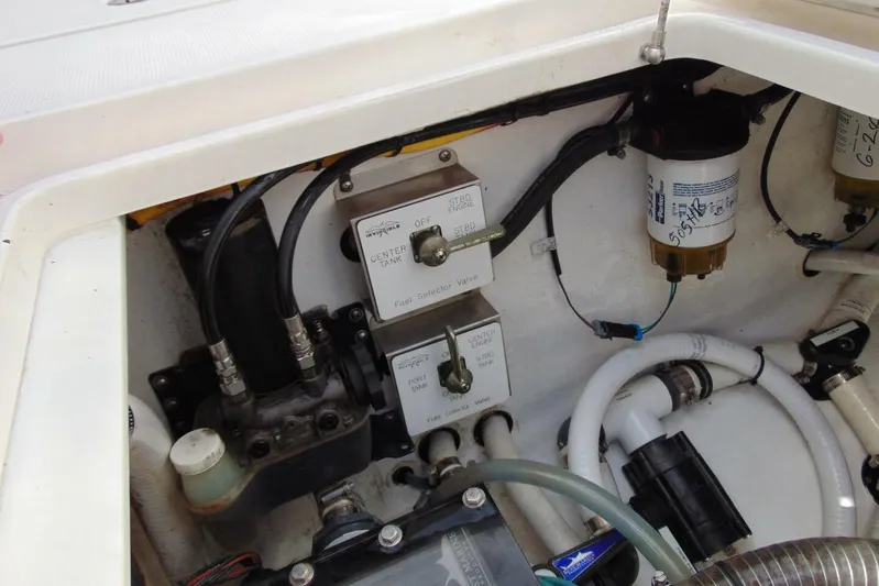 Incognito Yacht Photos Pics Engine compartment of a 2020 Invincible 36 Open boat, showing fuel selector valves and hoses.