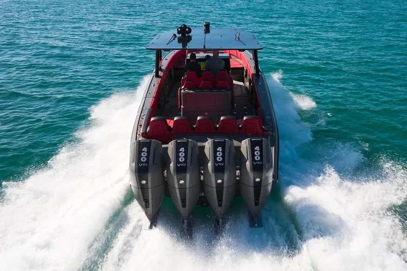  Yacht Photos Pics 2023 Midnight Express 37' Open boat with quad 400 V10 engines cruising on blue water.