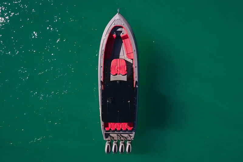  Yacht Photos Pics Aerial view of 2023 Midnight Express 37' Open boat on turquoise water.