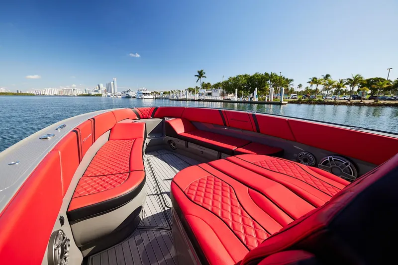 Yacht Photos Pics 2023 Midnight Express 37' Open boat with luxurious red seating, docked by a scenic marina.