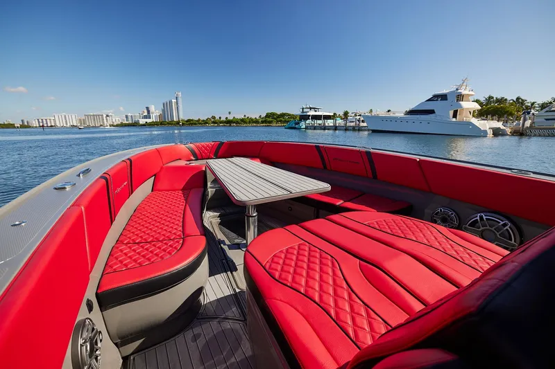  Yacht Photos Pics Luxurious 2023 Midnight Express 37' Open boat with red seating, docked in a scenic marina.