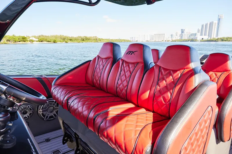  Yacht Photos Pics Luxurious red seating on 2023 Midnight Express 37' Open boat, with scenic waterfront view.