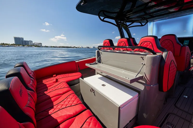  Yacht Photos Pics Luxurious 2023 Midnight Express 37' Open boat with red seating, cruising on a sunny day.